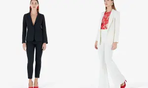 Modelli con giacca e pantaloni eleganti. Una con giacca nera e pantaloni slim, l'altra con giacca bianca e pantaloni a zampa.