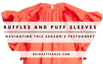 A bright orange top with voluminous ruffles and puff sleeves, overlaid with text.