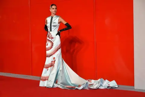 Modella con abito azzurro e draghi rossi, un look da tappeto rosso a look venezia.
