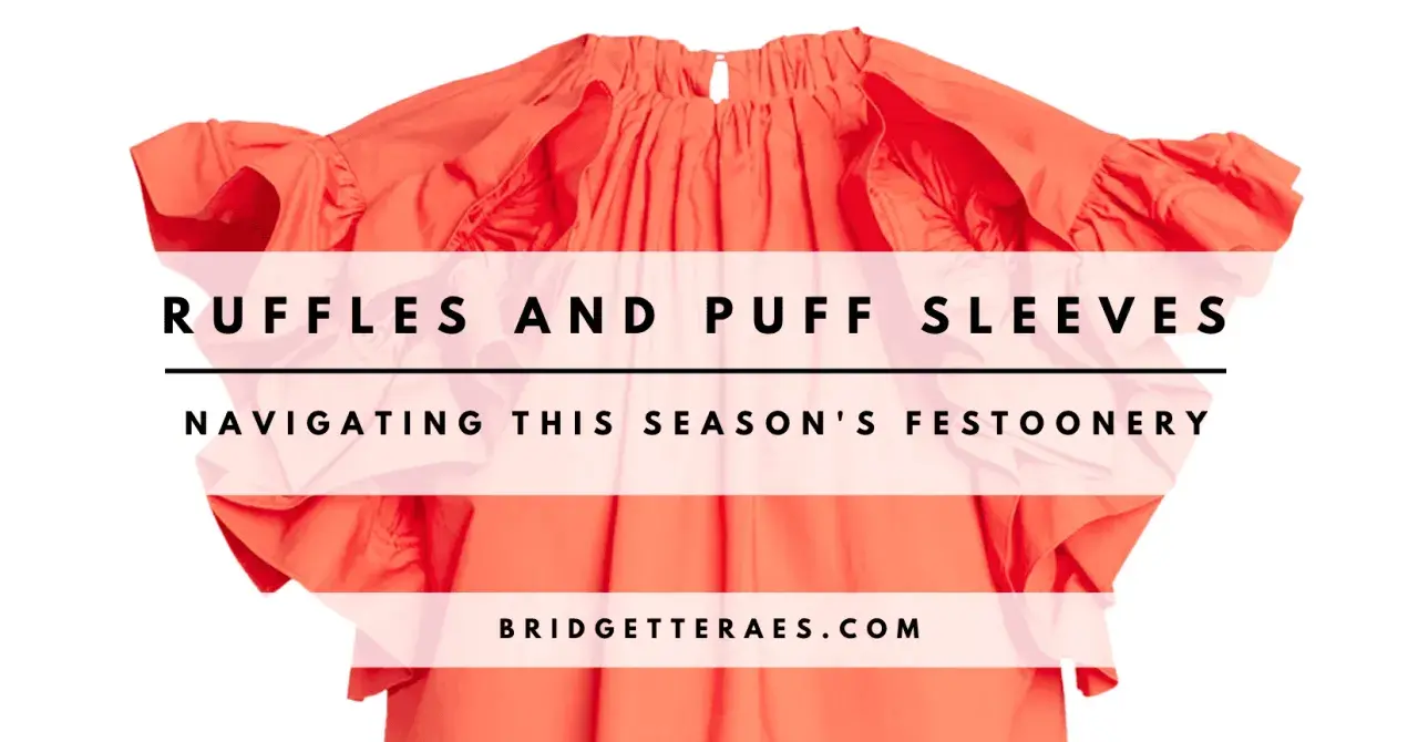 A bright orange top with voluminous ruffles and puff sleeves, overlaid with text.