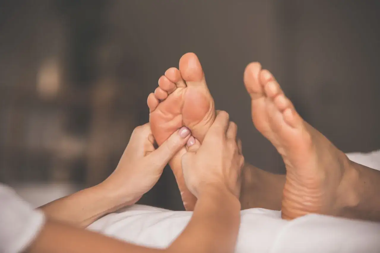 Mani esperte mostrano come massaggiare i piedi con delicatezza, alleviando la tensione e promuovendo il benessere.