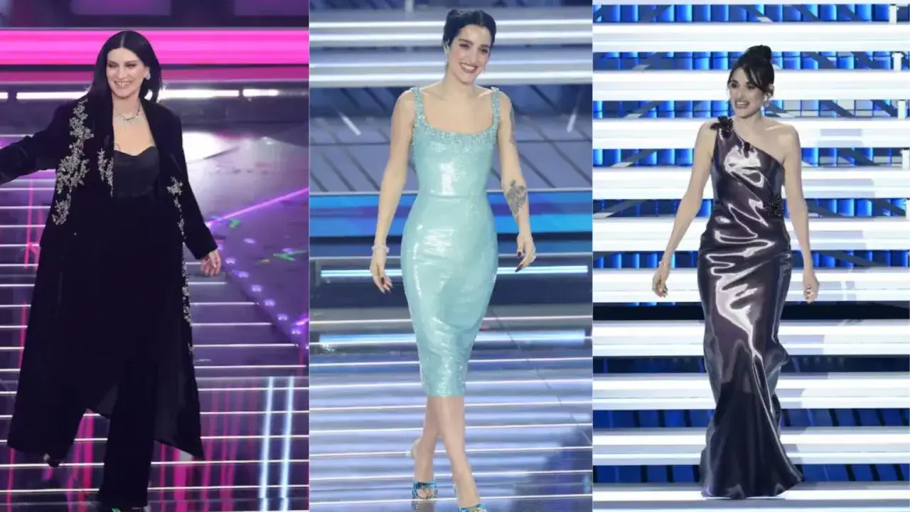 Tre donne sul palco di Sanremo: una in abito nero elegante, una in vestito azzurro scintillante e l'altra in un abito di raso metallizzato.
